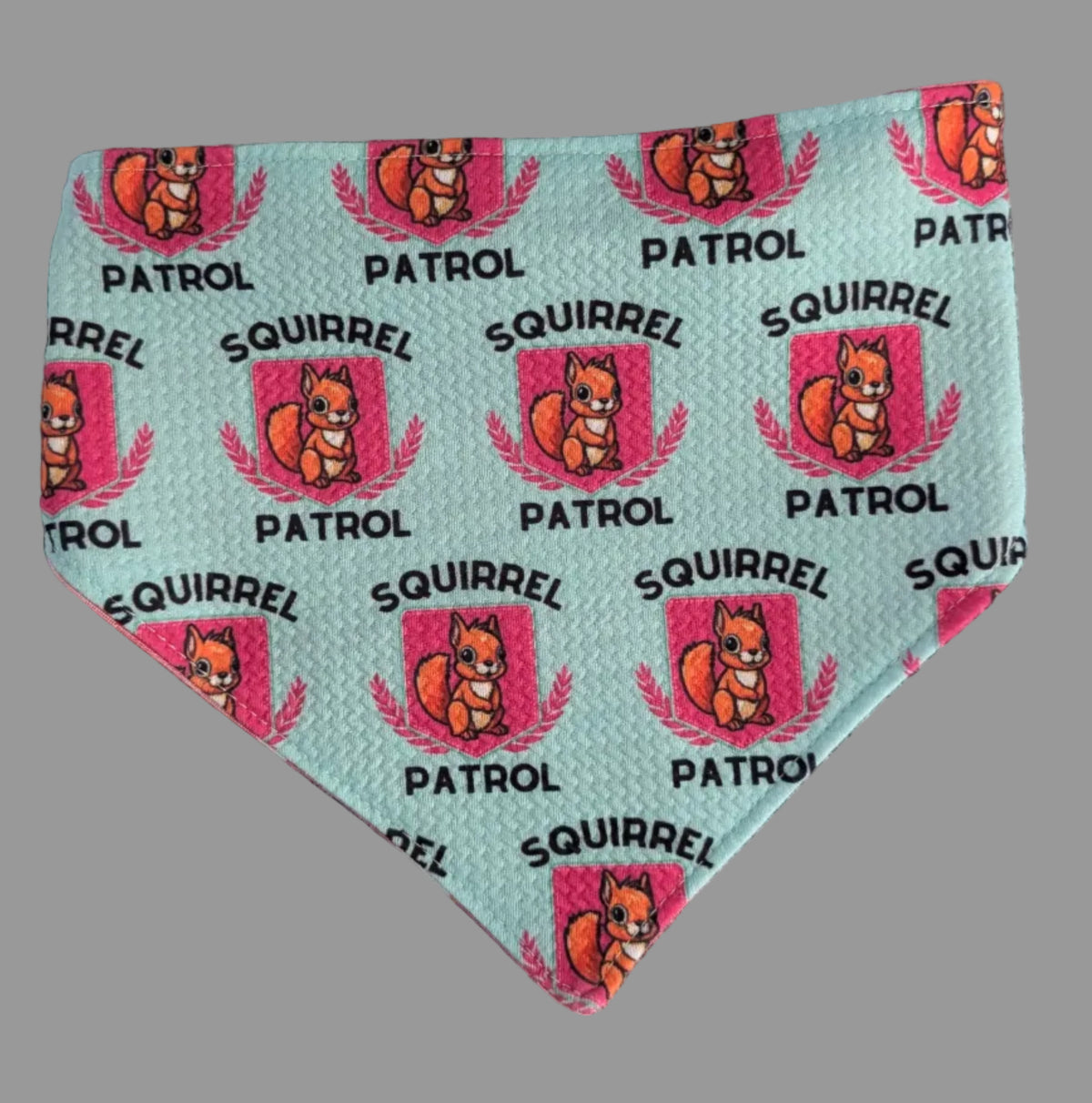 Mint bandana with pink Squirrel Patrol badges featuring a squirrel